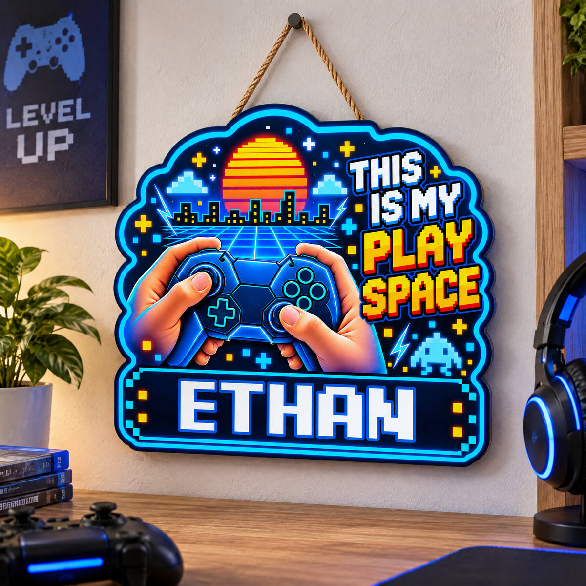 Personalized wooden sign gamer controller hanging on a wall beside a plant, headphones and game controller on desk