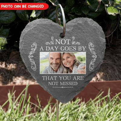 Decorative slate plaque with photo of an elderly couple and text in a garden setting