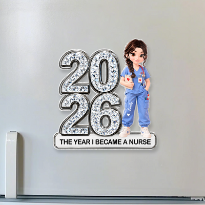 Personalized Acrylic Fridge Magnet Nurse with 2026 and a braided nurse in blue scrubs on a light gray fridge