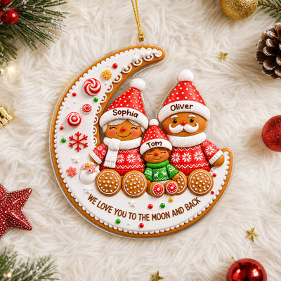 Gingerbread Family Moon Personalize Acrylic Ornament held by a hand near a lit Christmas tree
