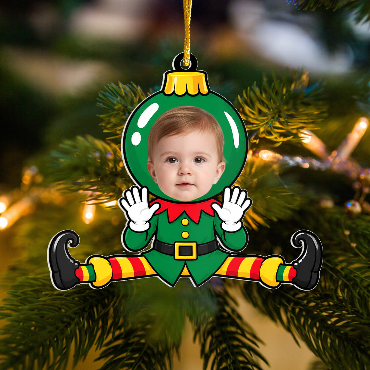 Personalized Acrylic Christmas Photo Ornament with baby face in green elf costume doing splits, hanging on a tree