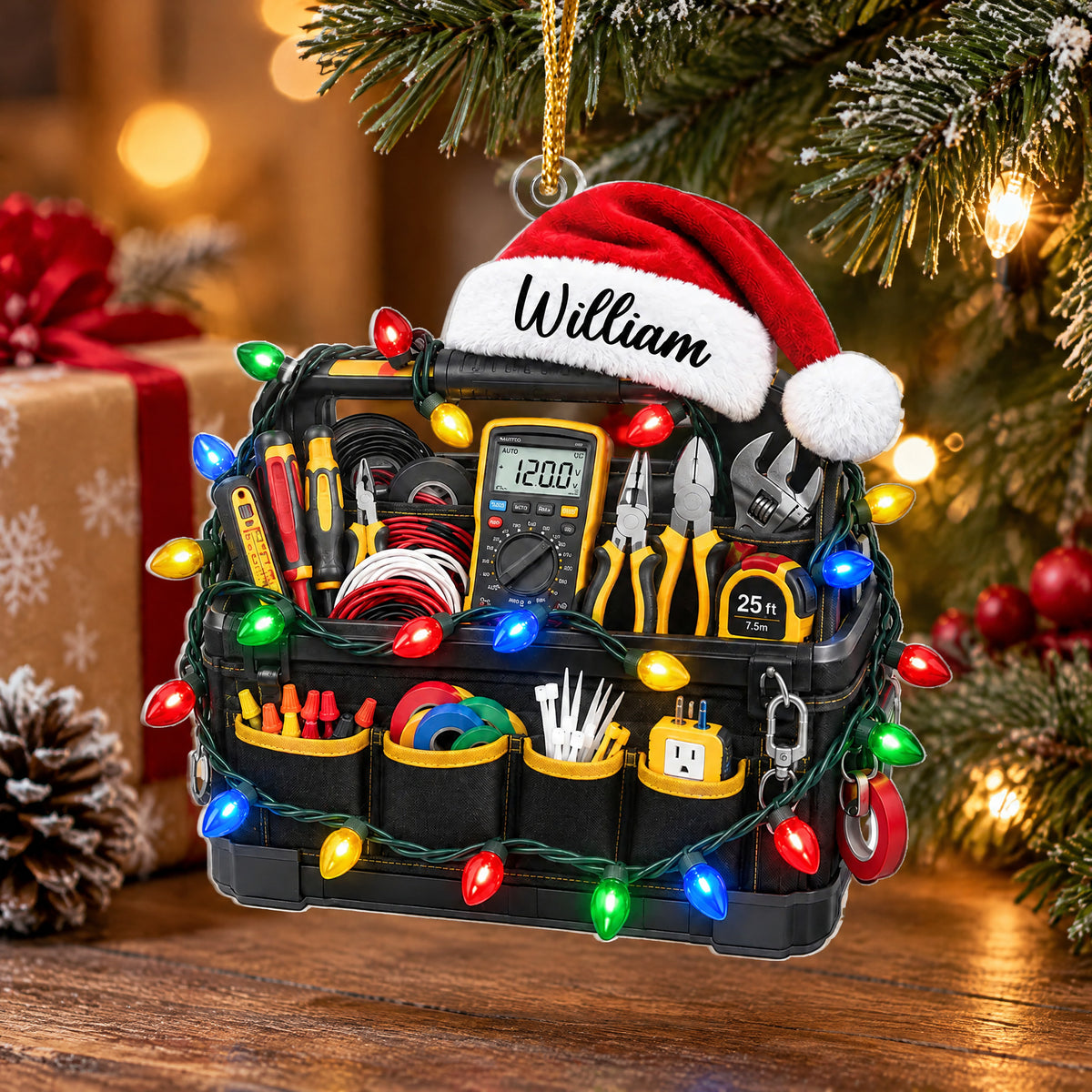 Personalized electrician tool bag acrylic ornament by a wrapped gift and pinecone on a wooden surface
