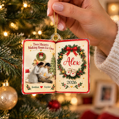 Personalized acrylic ornament Two Hearts Making Room For One held by a hand in a cozy sweater by the tree