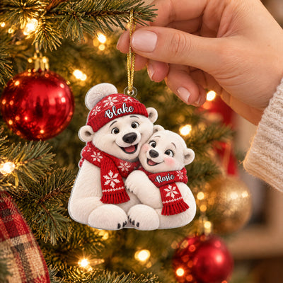 Personalized polar bear couple acrylic ornament held up on a Christmas tree with red and gold baubles