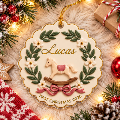 Personalized rocking horse baby acrylic ornament flat on a cream fluffy rug with pine, lights and a wrapped gift
