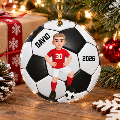 Personalized soccer acrylic ornament on a wooden table with a wrapped gift, pinecone and snowflake cookies