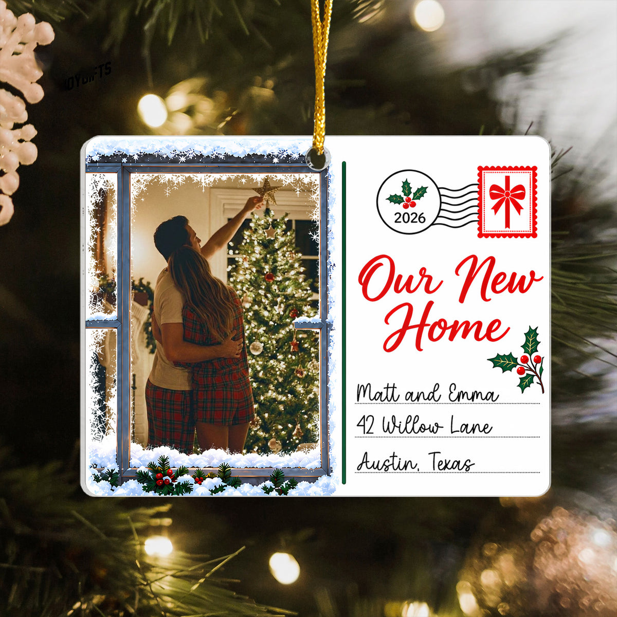 Personaliozed Rectangular Acrylic Ornament hanging on a lit tree, couple hugging by a tree in a snowy window photo