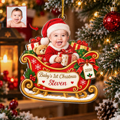 Personalized Custom Baby Face Acrylic Ornament hanging on a Christmas tree beside a red bauble, with a small baby photo inset