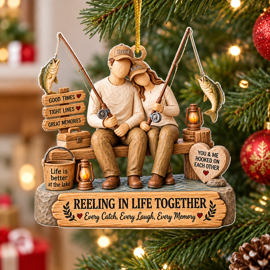 Personalized Acrylic Ornament Reeling In Life Together hanging on a pine branch beside red glitter baubles