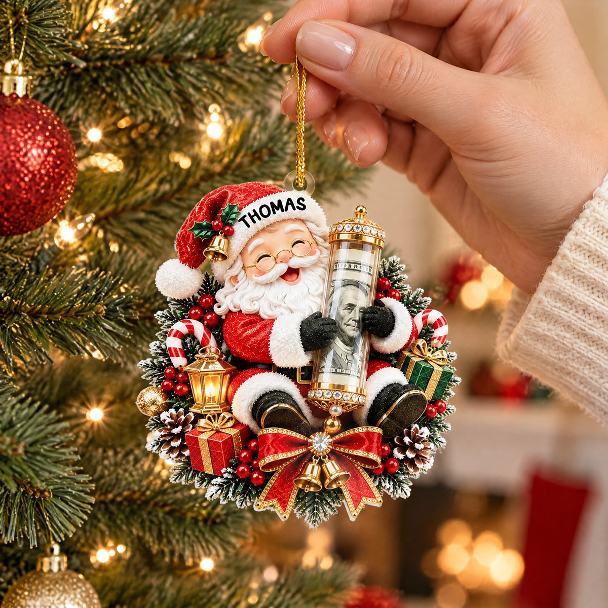 Personalized Acrylic Ornament Money Holder with Santa design held by a hand near a lit Christmas tree