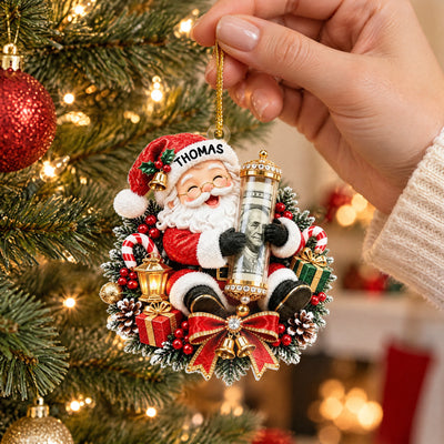 Personalized Acrylic Ornament Money Holder with Santa design held by a hand near a lit Christmas tree