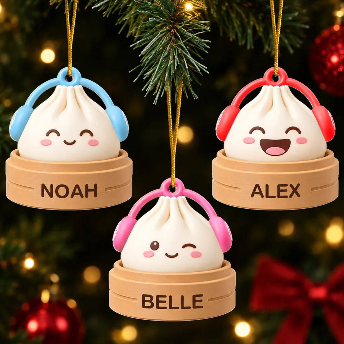 Personalized acrylic dumpling ornament set of three in blue, red and pink earmuffs, hanging on a Christmas tree