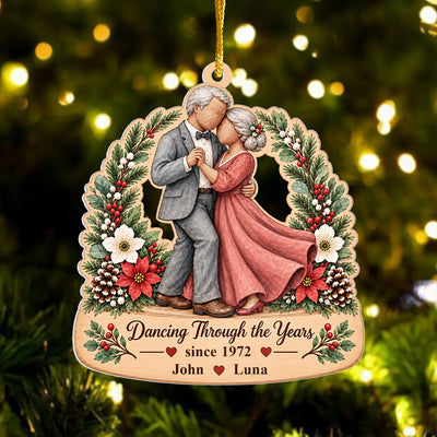 Personalized Vintage Watercolor Dancing Couple Ornament hanging on a lit Christmas tree, with names David and Sarah