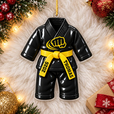Personalized karate uniform acrylic ornament in black with yellow belt lying on white fur with holiday decor