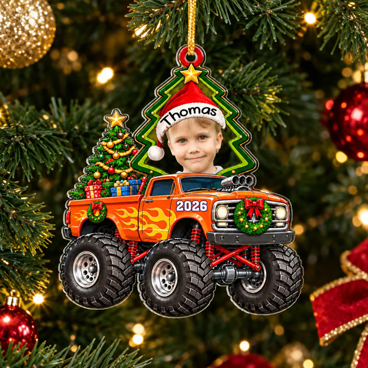 Monster Truck Personalized Acrylic Ornament hanging on a decorated Christmas tree with warm lights