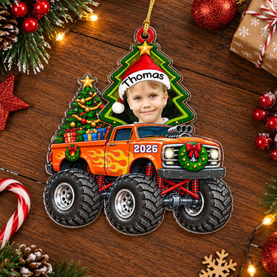 Monster Truck Personalized Acrylic Ornament lying on a wooden table with candy cane, pinecones and red baubles
