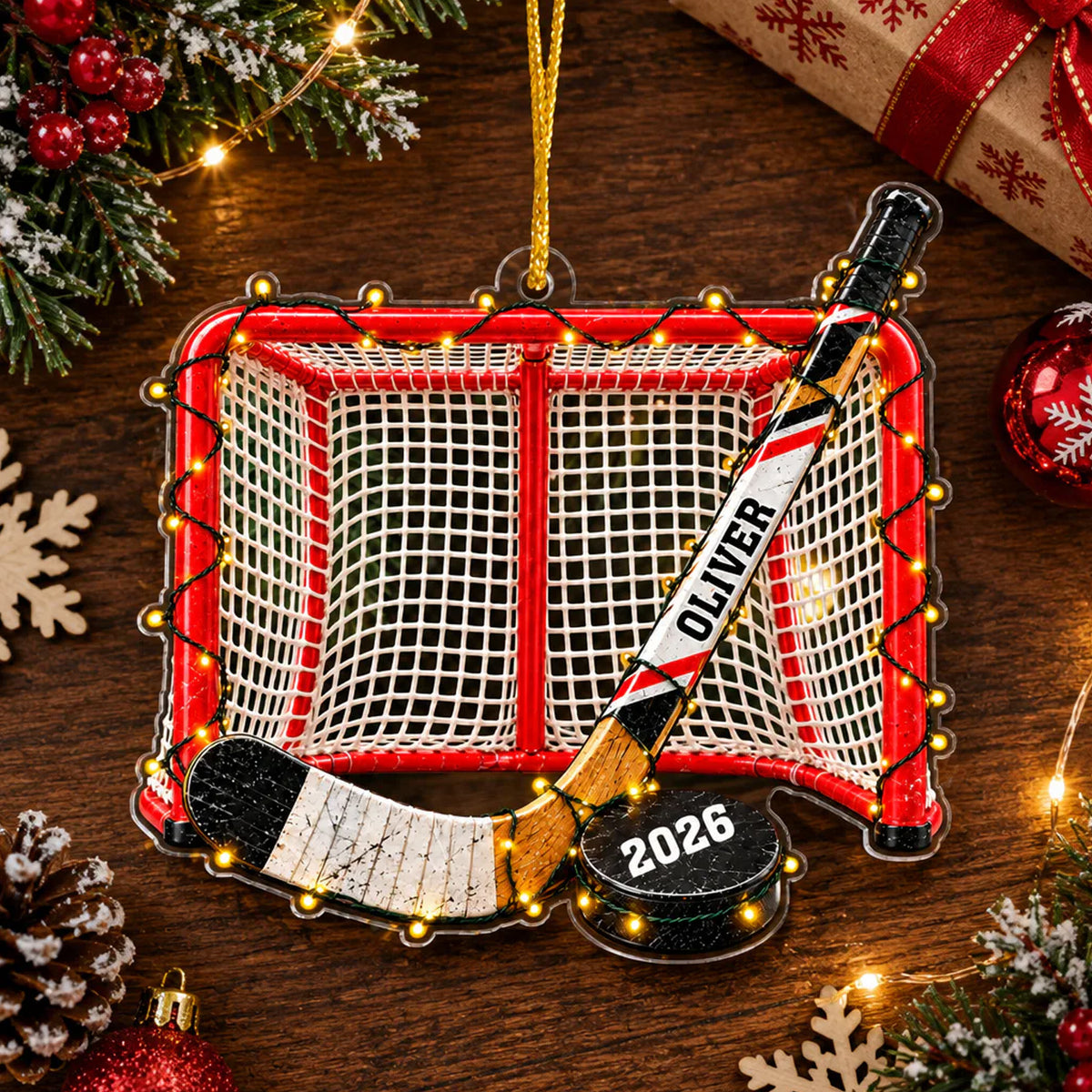 Personalized Acrylic Hockey Ornament on a wooden table with pine branches, snowflakes and a wrapped gift