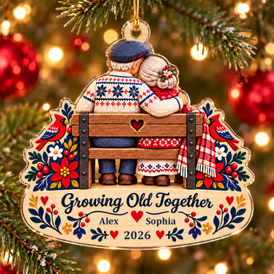 Growing Old Together Personalized Acrylic Ornament hanging on a snowy branch near white candles and warm lights