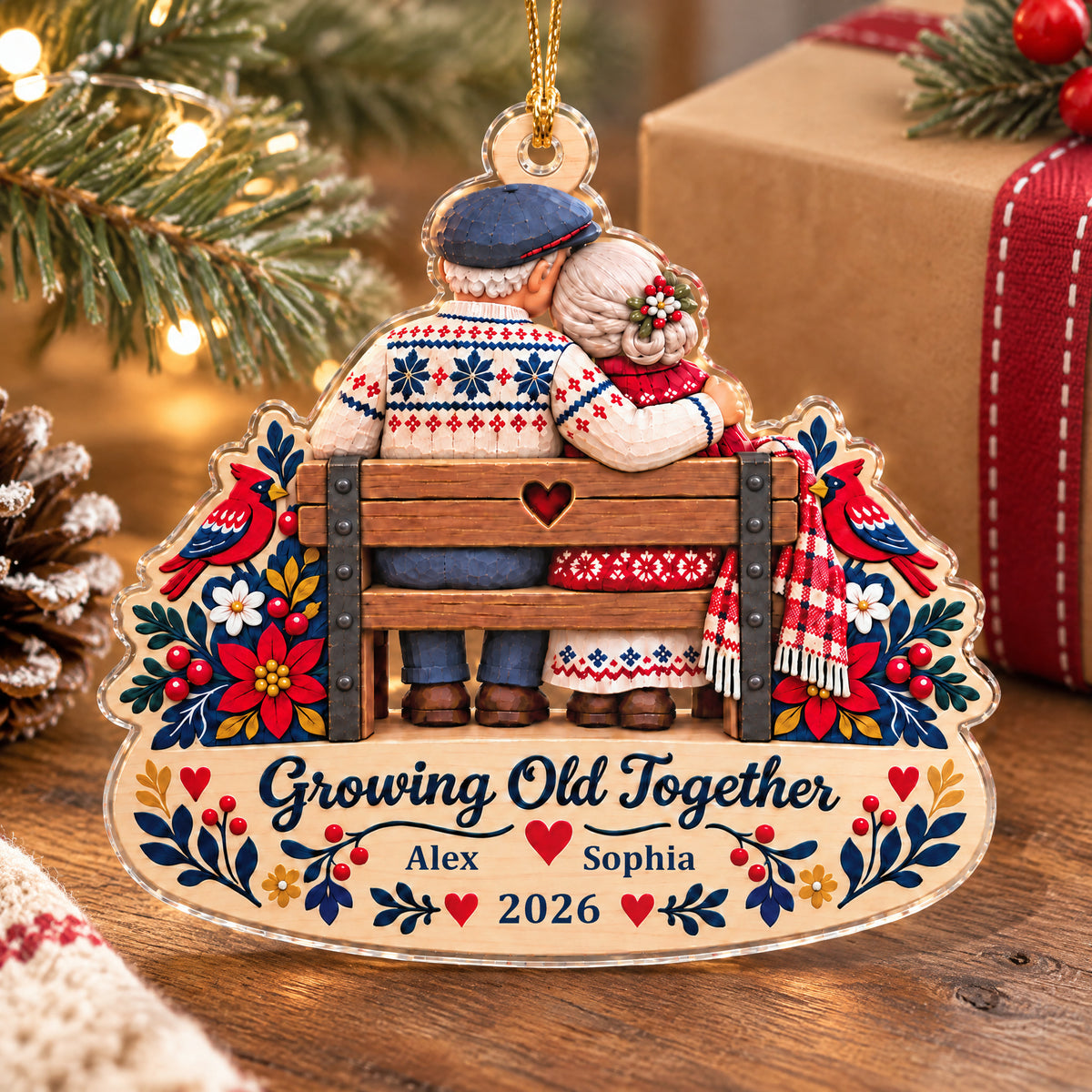 Growing Old Together Personalized Acrylic Ornament standing on a wooden table by a wrapped gift and pinecone