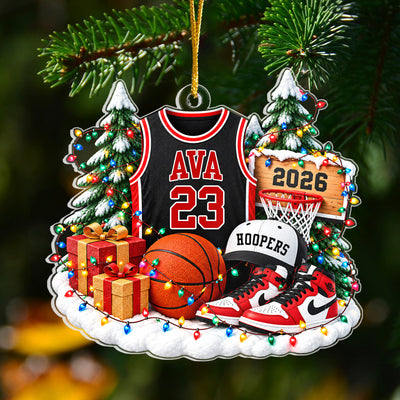 Personalized Basketball Acrylic Ornament hanging from a green pine branch against a dark background