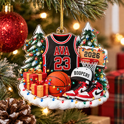 Personalized Basketball Acrylic Ornament on a tree beside a red bauble, pinecone and plaid wrapped gift