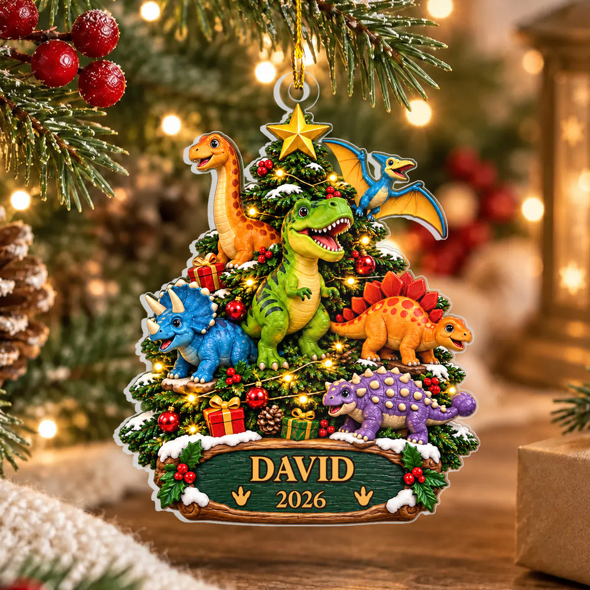 Personalized acrylic dinosaur ornament with name David 2026 hanging on a pine branch near warm lights