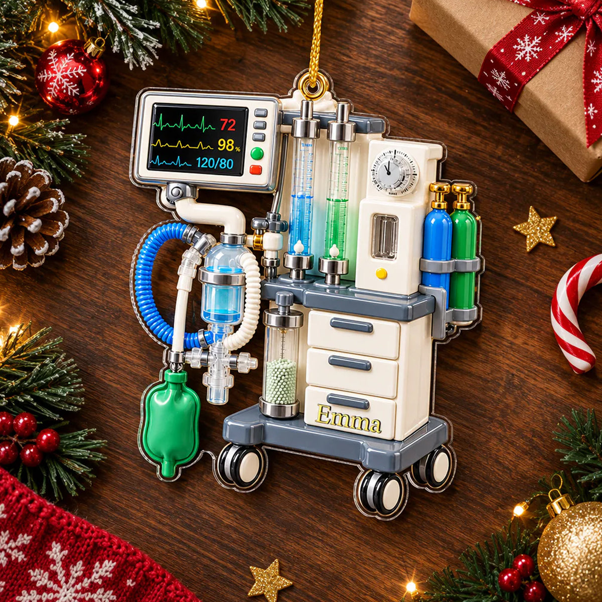 Personalized anesthesia machine acrylic ornament on a wood table with pine, pinecone, gift and candy cane, name Emma