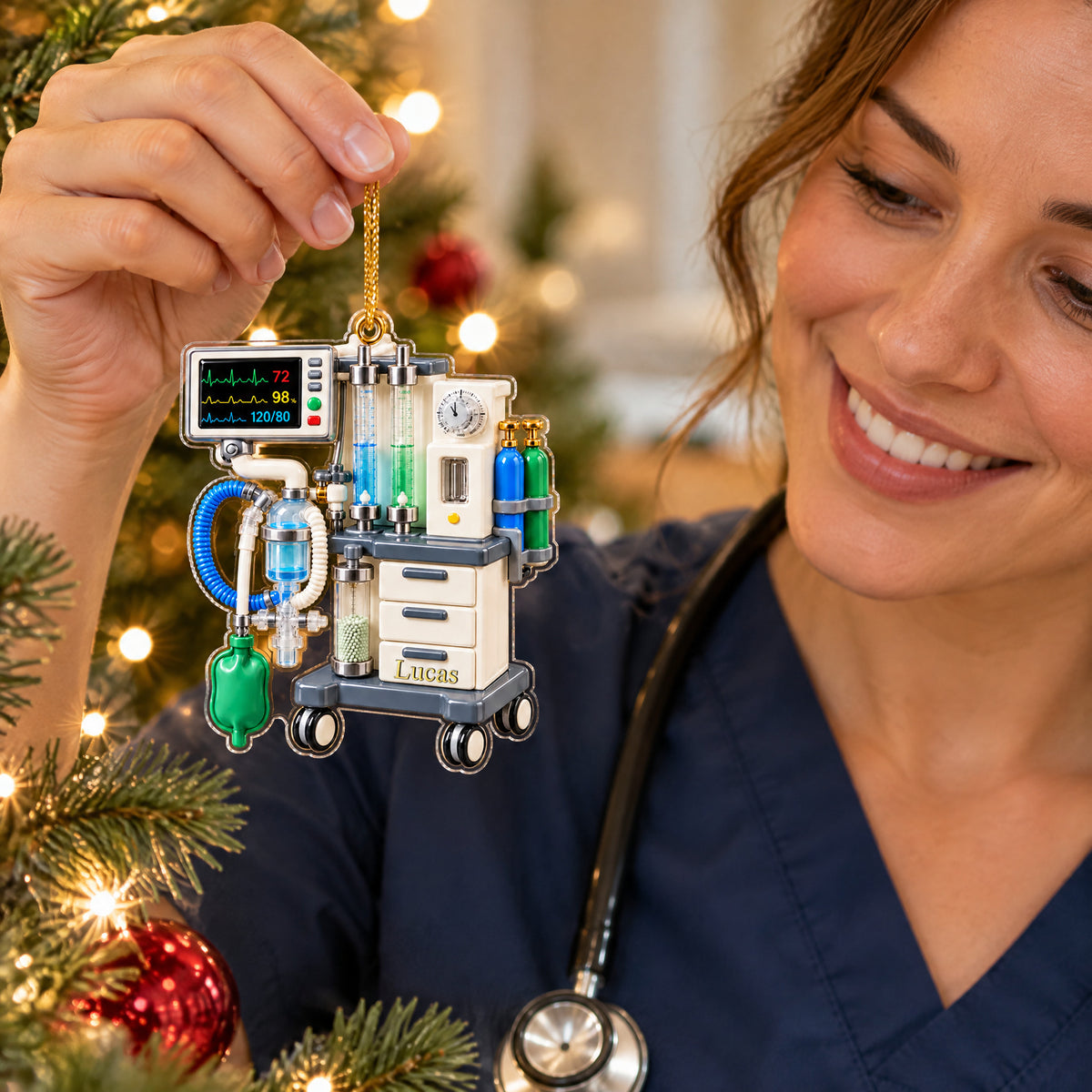 Personalized anesthesia machine acrylic ornament held up by a smiling person in navy scrubs with a stethoscope