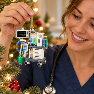 Personalized anesthesia machine acrylic ornament held up by a smiling person in navy scrubs with a stethoscope