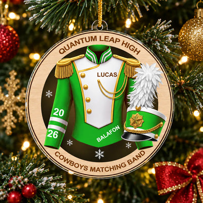 Personalized marching band acrylic ornament in green hanging on a tree with lights and a red bow