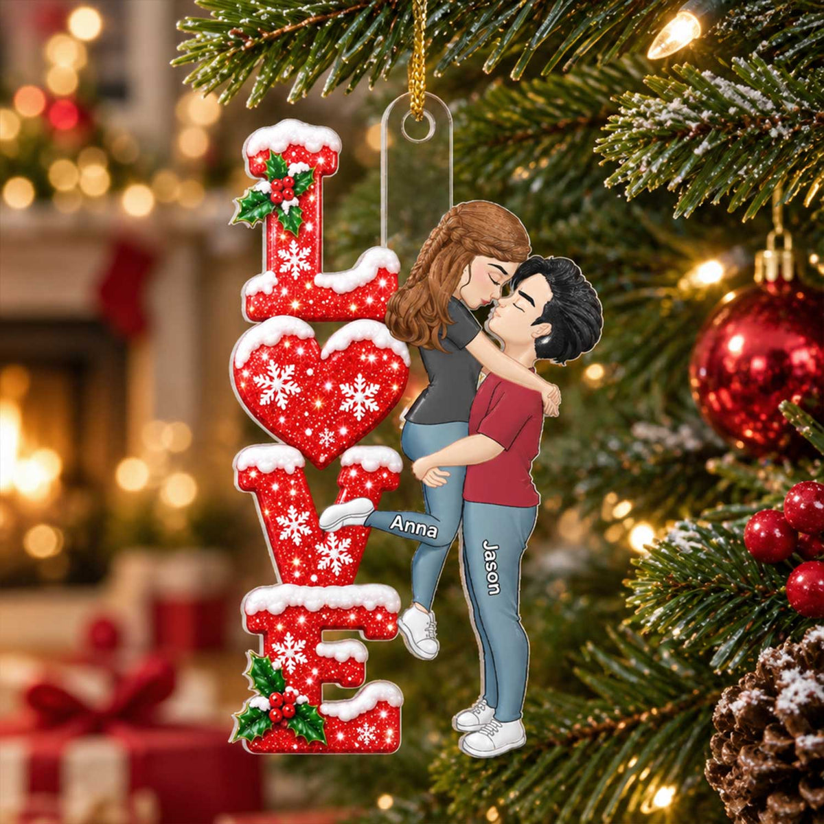 Personalized Acrylic Ornament Kissing Couple on a Christmas tree with a blurred fireplace behind, names Anna and Jason