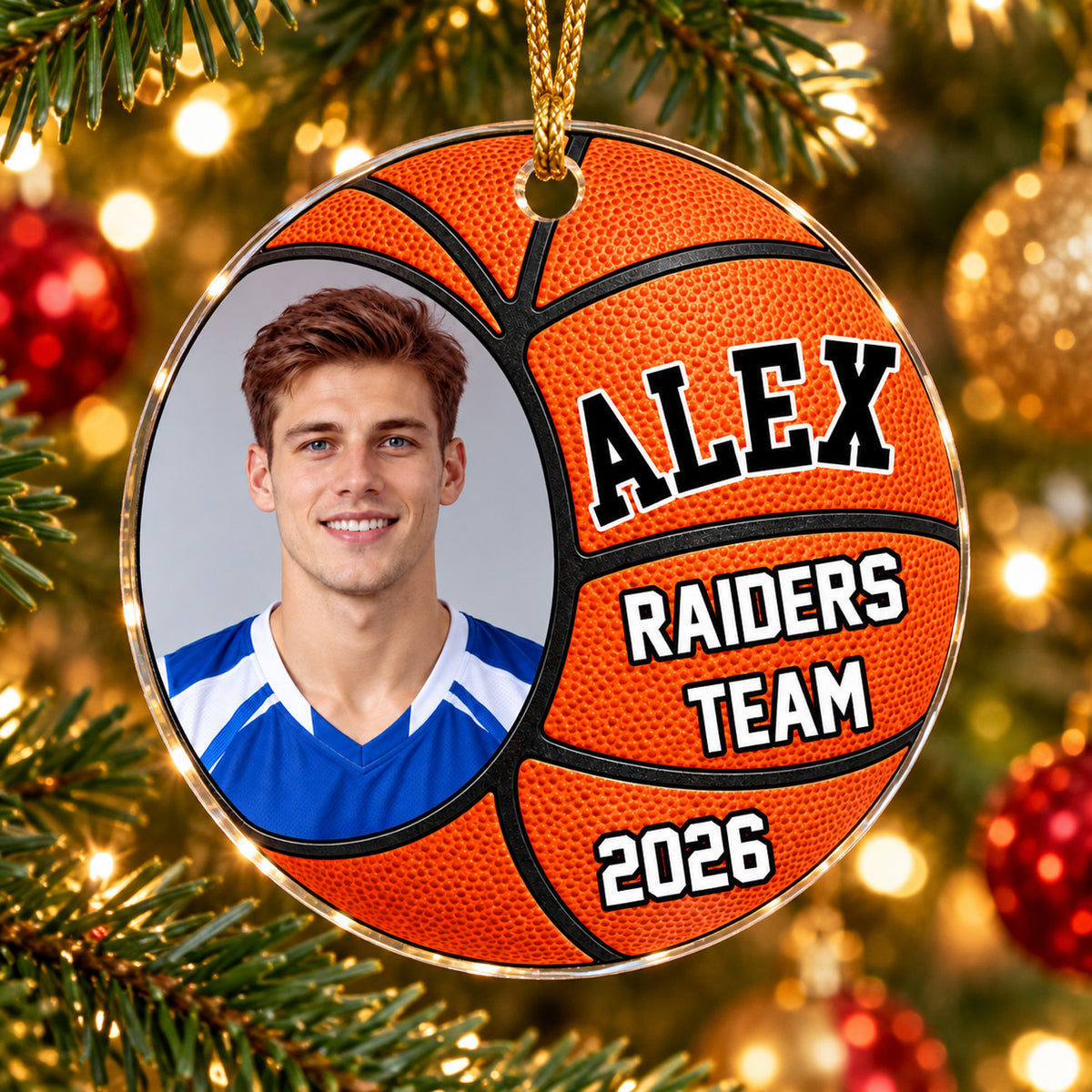 Personalized basketball acrylic ornament with player photo, name Alex and Raiders Team 2026 hanging on a lit tree