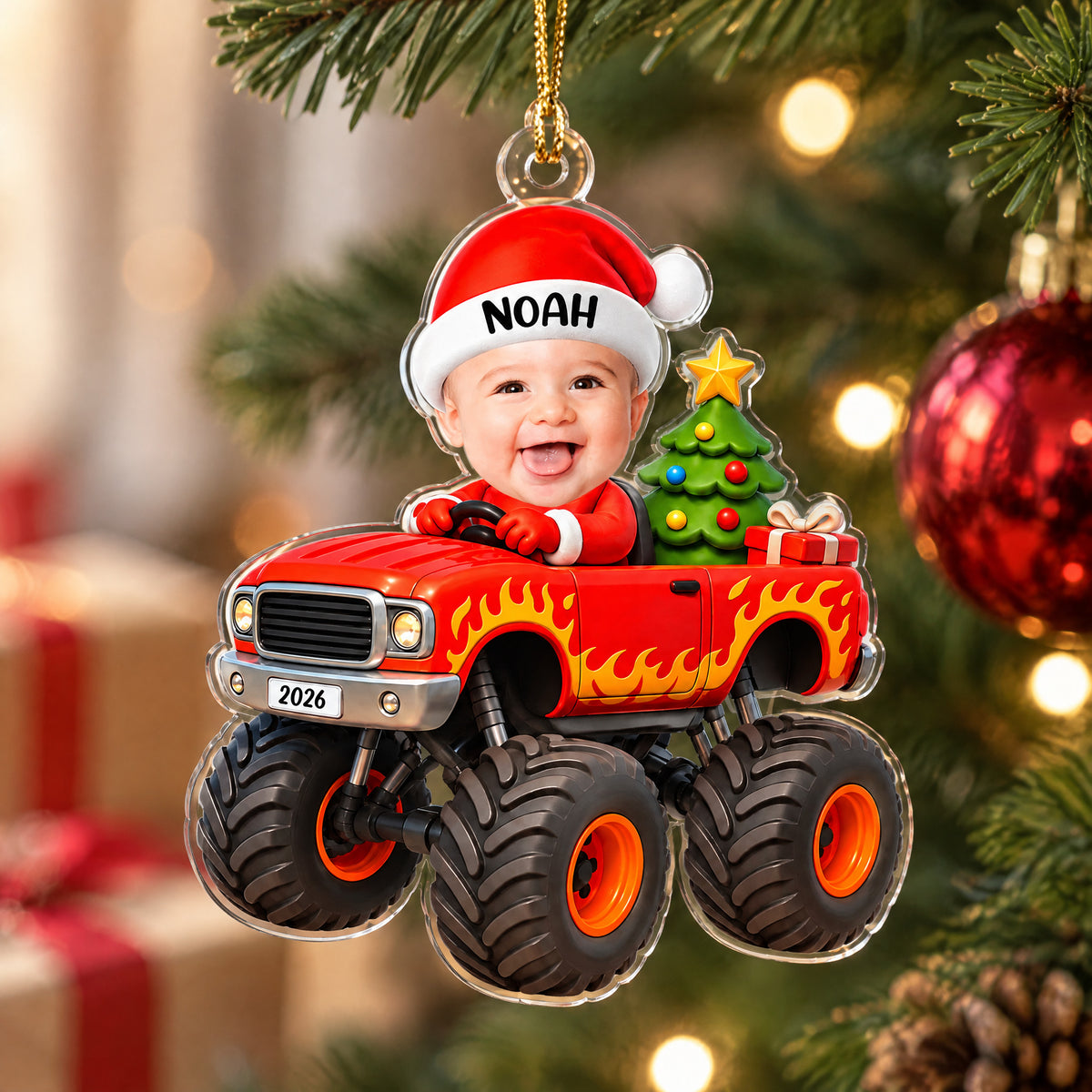 Personalized red monster truck acrylic ornament close up with clear edge, hanging near gifts and a red bauble