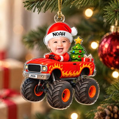 Personalized red monster truck acrylic ornament close up with clear edge, hanging near gifts and a red bauble