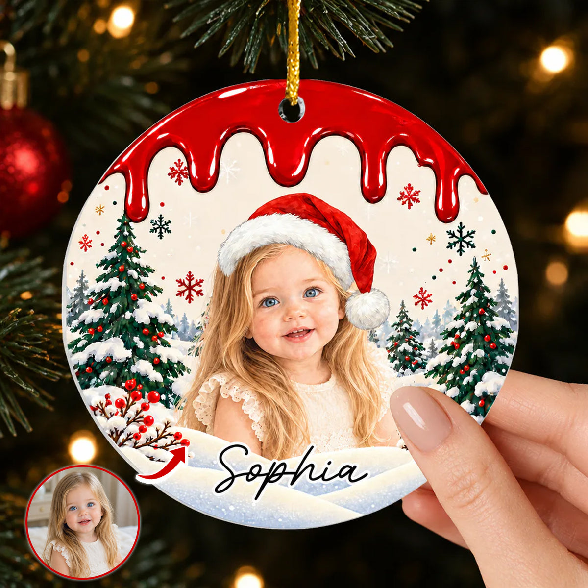 Personalized acrylic ornament custom photo with red drip top and girl in Santa hat, held in a hand