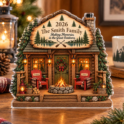 Personalized Family Cabin Acrylic Plaque with a wreath on the door, two chairs and a fire pit, mug nearby