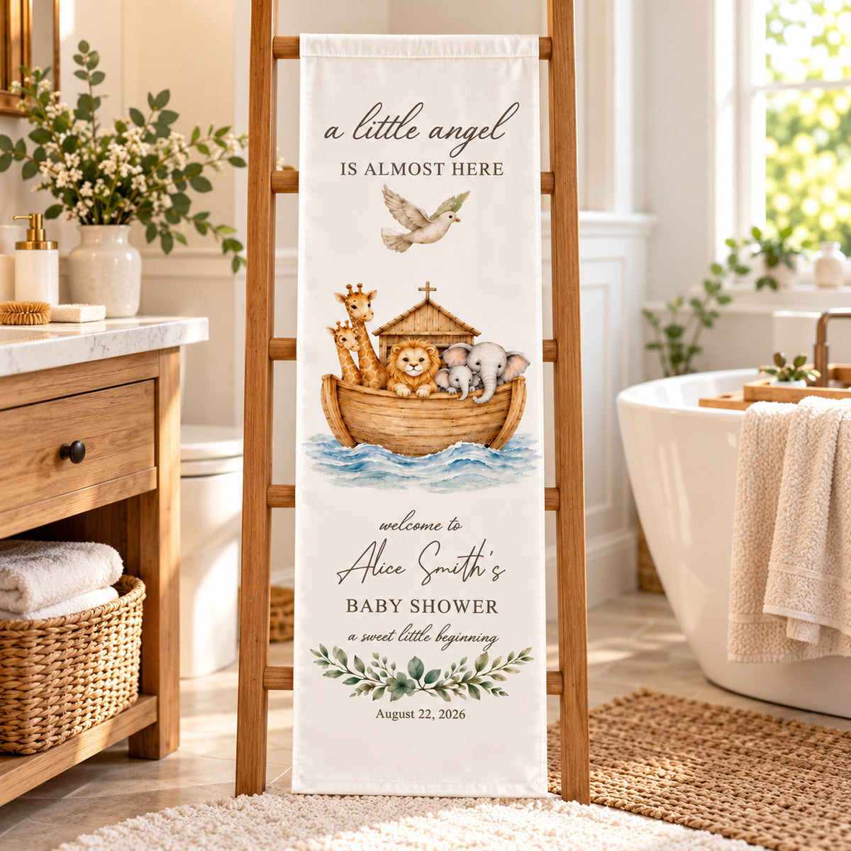 Personalized Baby Shower Backdrop draped on a wooden ladder in a bright bathroom beside a basket and bathtub