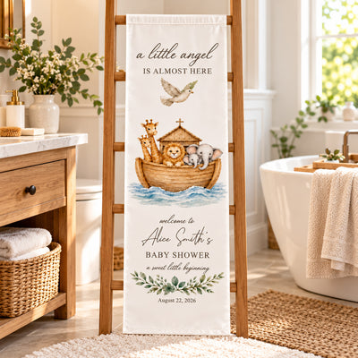 Personalized Baby Shower Backdrop draped on a wooden ladder in a bright bathroom beside a basket and bathtub