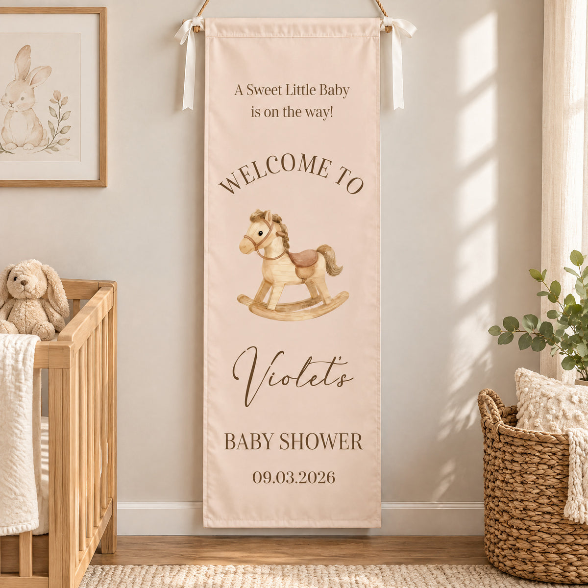 Personalized Baby Shower Welcome Backdrop with rocking horse in a nursery beside a wooden crib and woven basket