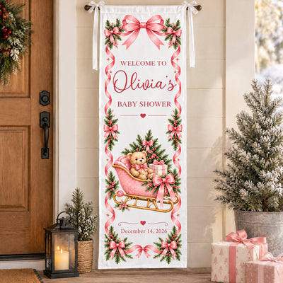 Personalized Pink Teddy Bear Sleigh Banner hanging beside a wooden front door with a wreath, lantern and snowy tree