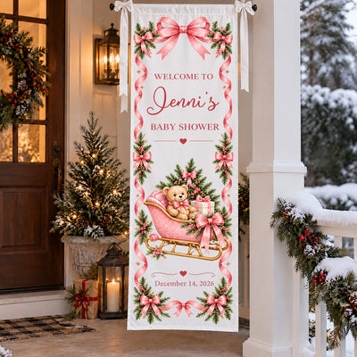 Personalized Pink Teddy Bear Sleigh Banner on a snowy porch with a lit tree, lantern and garland at dusk