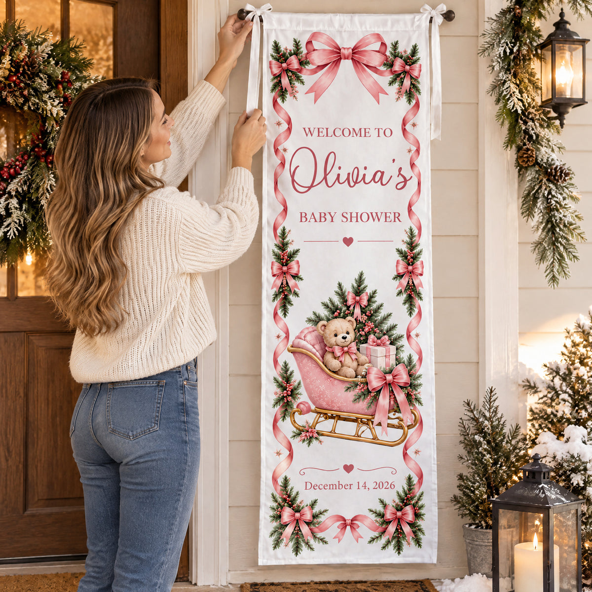 Personalized Pink Teddy Bear Sleigh Banner being hung on a porch rod by a woman in a cream sweater