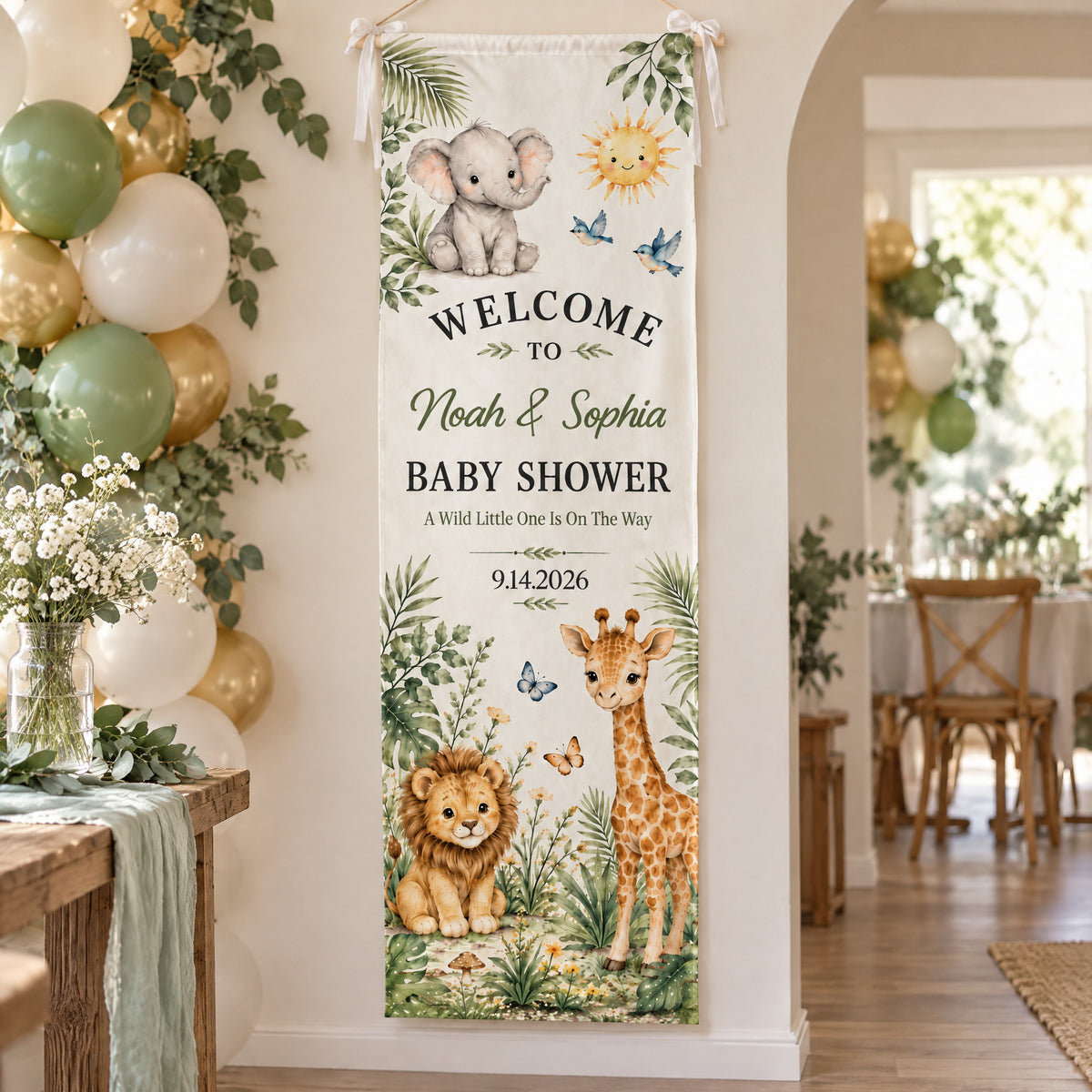 Personalized Safari Baby Shower Banner hanging on a wall with bows near balloons and a flower table
