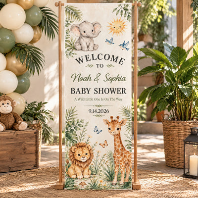 Personalized Safari Baby Shower Banner on a wooden stand outdoors with balloons, plush monkey and lantern