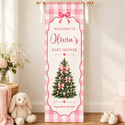 Custom Baby Shower Banner Pink Gingham hanging on a wall near a plush bunny, flowers and baby booties