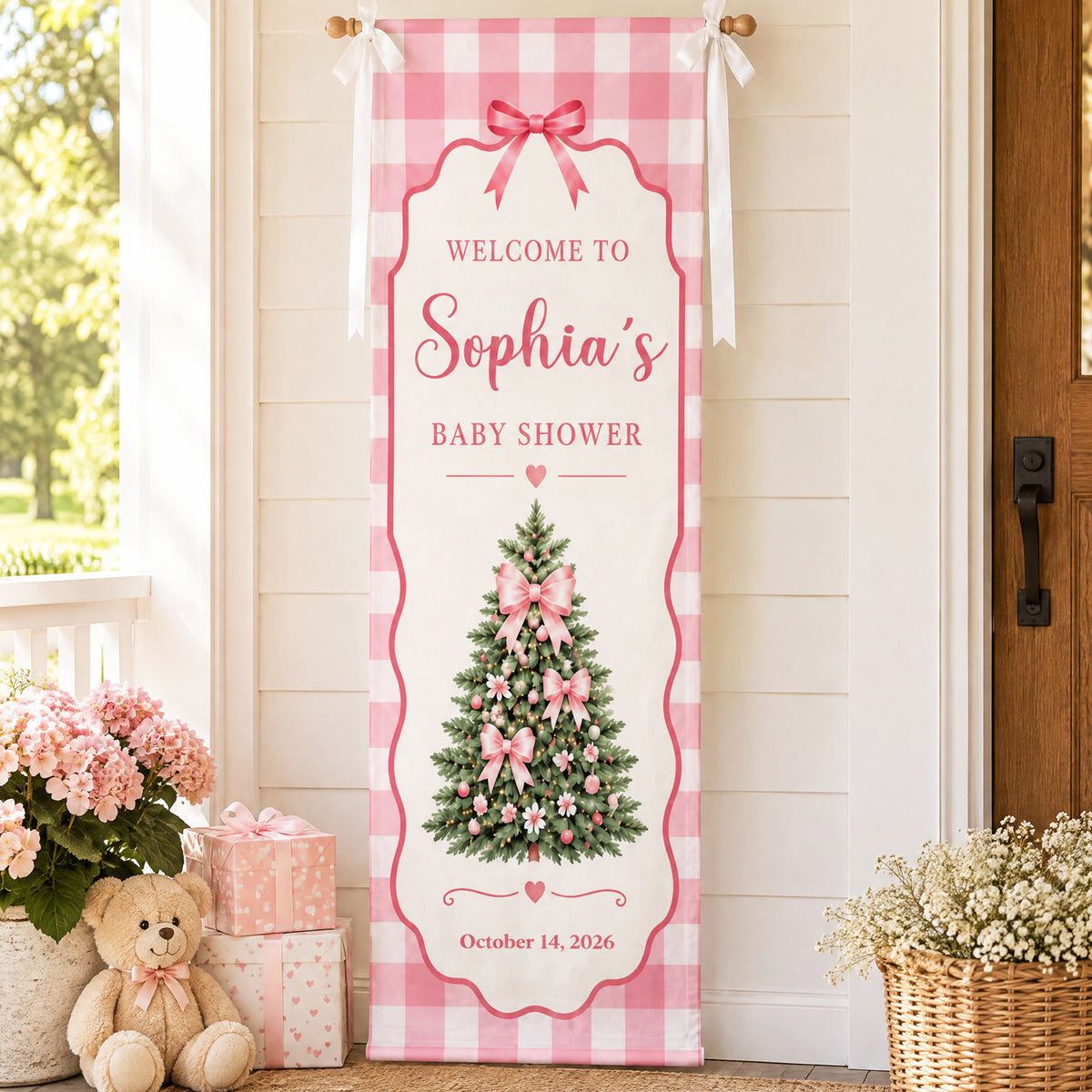 Custom Baby Shower Banner Pink Gingham on a porch wall by a front door, with gift boxes and a teddy bear