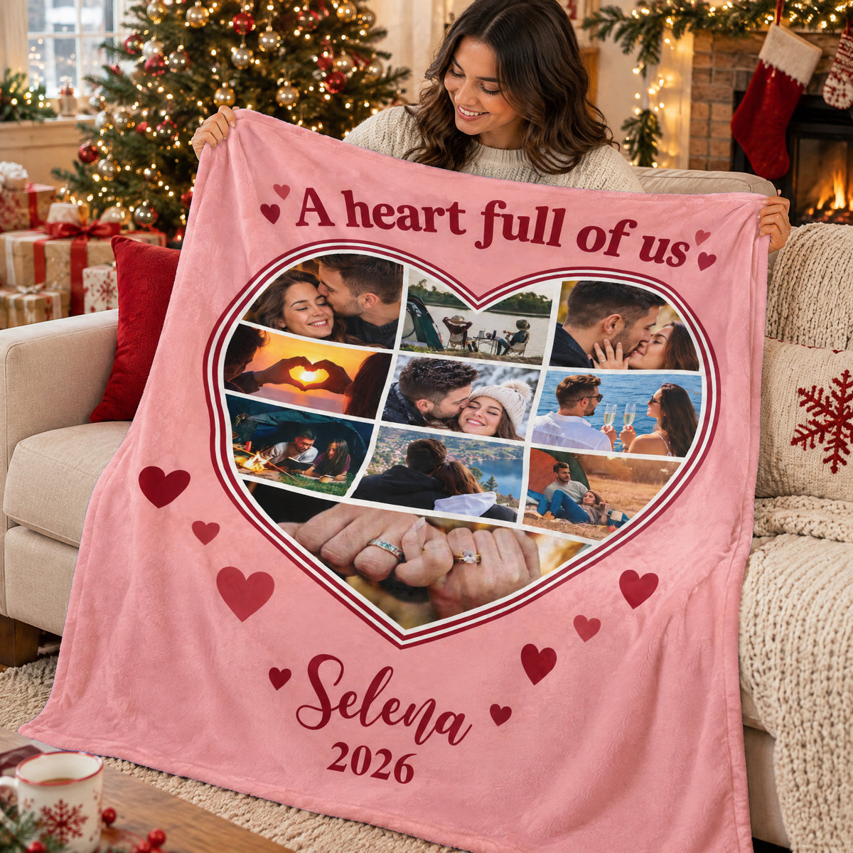 Personalized heart photo blanket held by a smiling woman near a decorated Christmas tree and fireplace