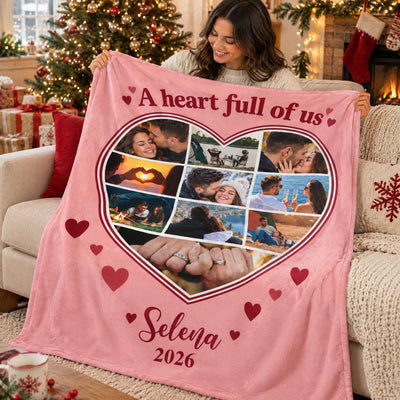 Personalized heart photo blanket held by a smiling woman near a decorated Christmas tree and fireplace