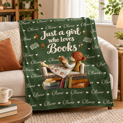 Personalized Custom Name Book Lover Blanket draped over a beige sofa beside pillows, a mug and a window