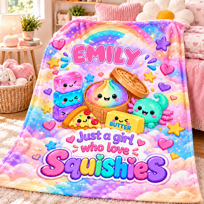 Personalized squishy blanket custom name laid on a bed in a pink room with a basket, lamp and plush toys